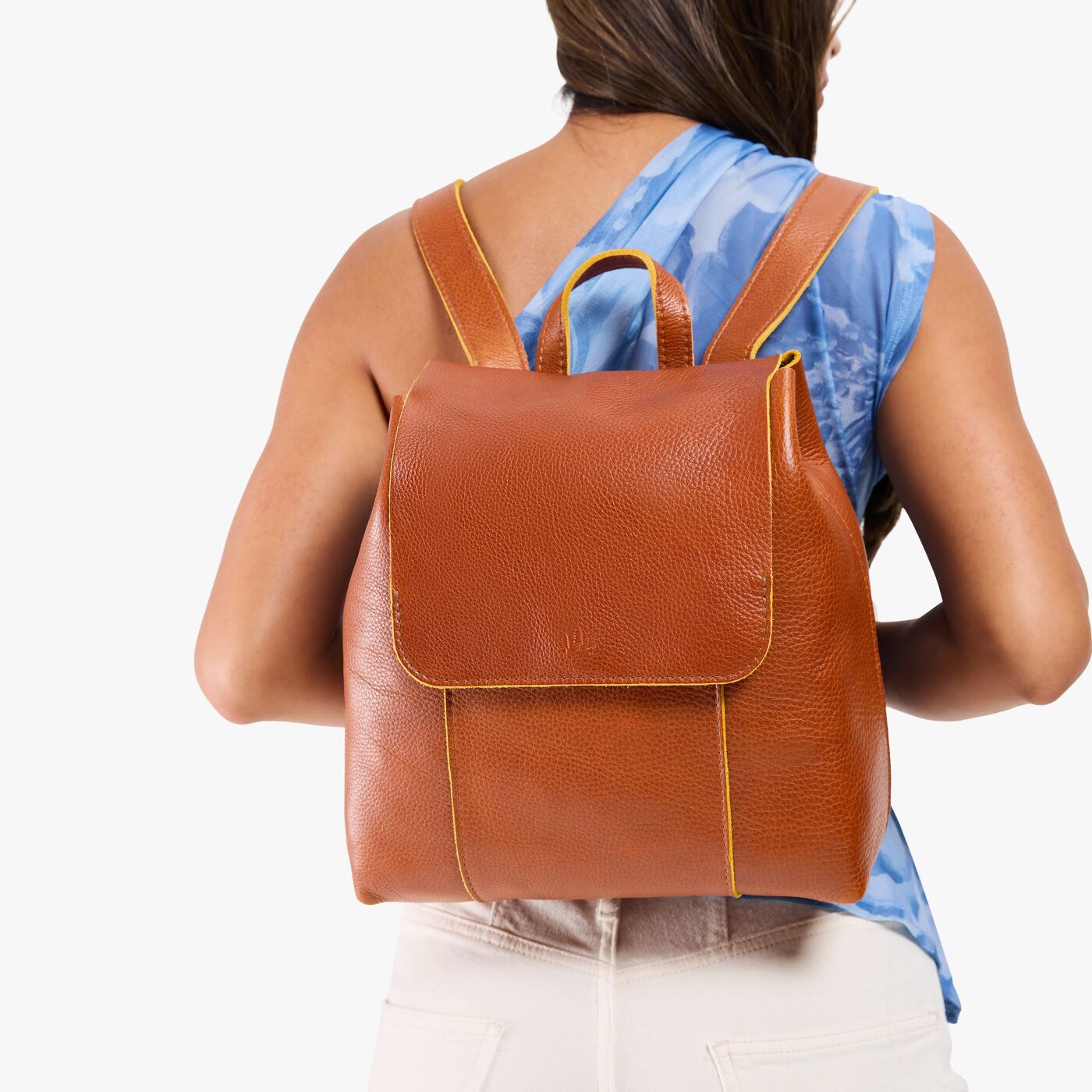 Sienna | Model wearing a leather backpack on a white background