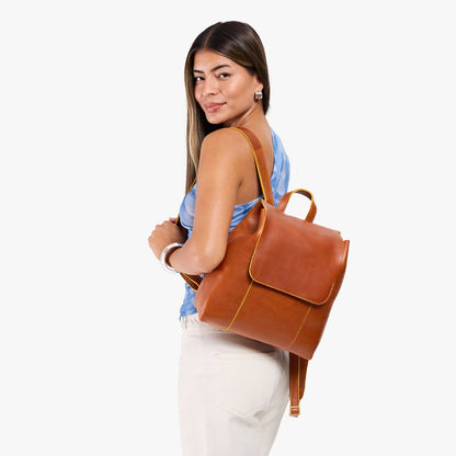 Sienna | Model wearing a leather backpack on a white background