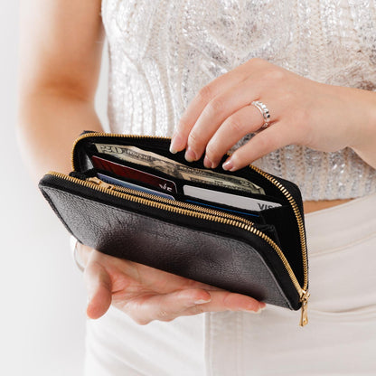 Pebbled--black | Model holding large accordion leather wallet with zipper