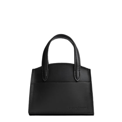 Black*Mini | Leather tote bag with handles, adjustable crossbody strap, zipper top, and a back pocket