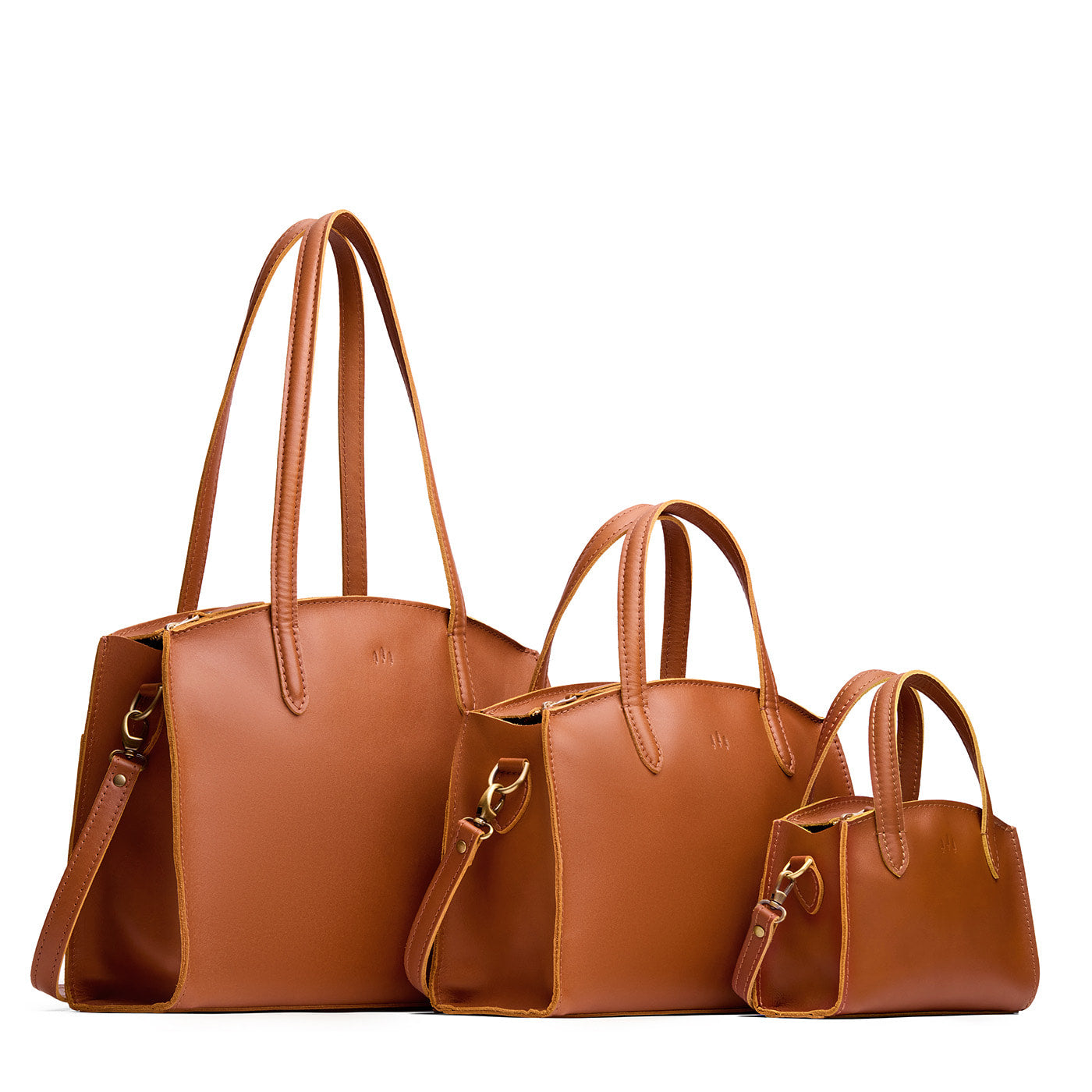 Honey | Size comparison image of Mini, Medium, and Large-sized leather tote bags with handles, adjustable crossbody strap, zipper top, and back pockets