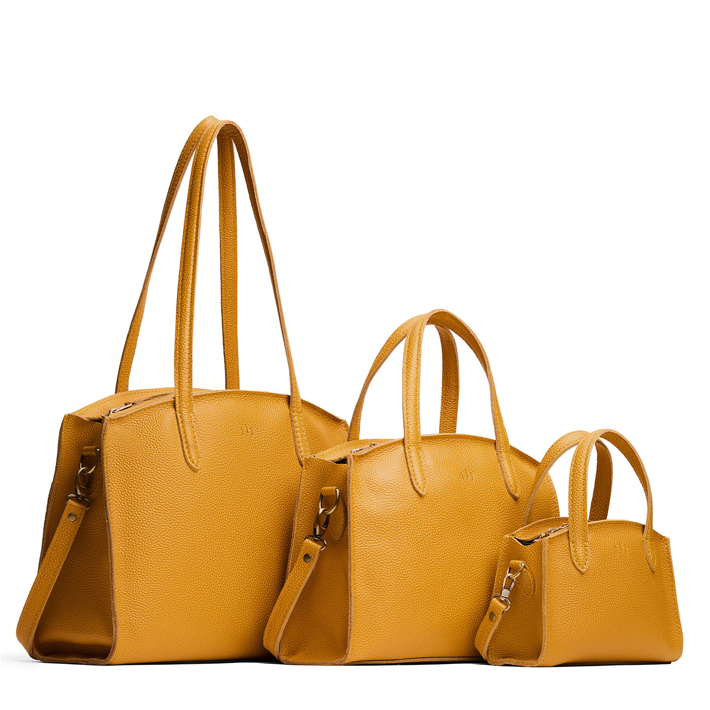 Sunshine | Size comparison image of Mini, Medium, and Large-sized leather tote bags with handles, adjustable crossbody strap, zipper top, and back pockets