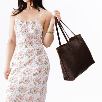 Coldbrew*Large | Model holding leather tote bag with interior snap key loop