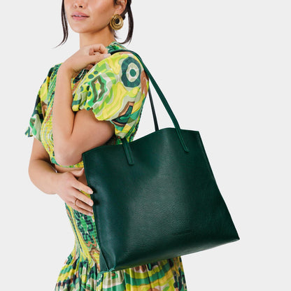 Forest Green*Large | Model holding leather tote bag with interior snap key loop