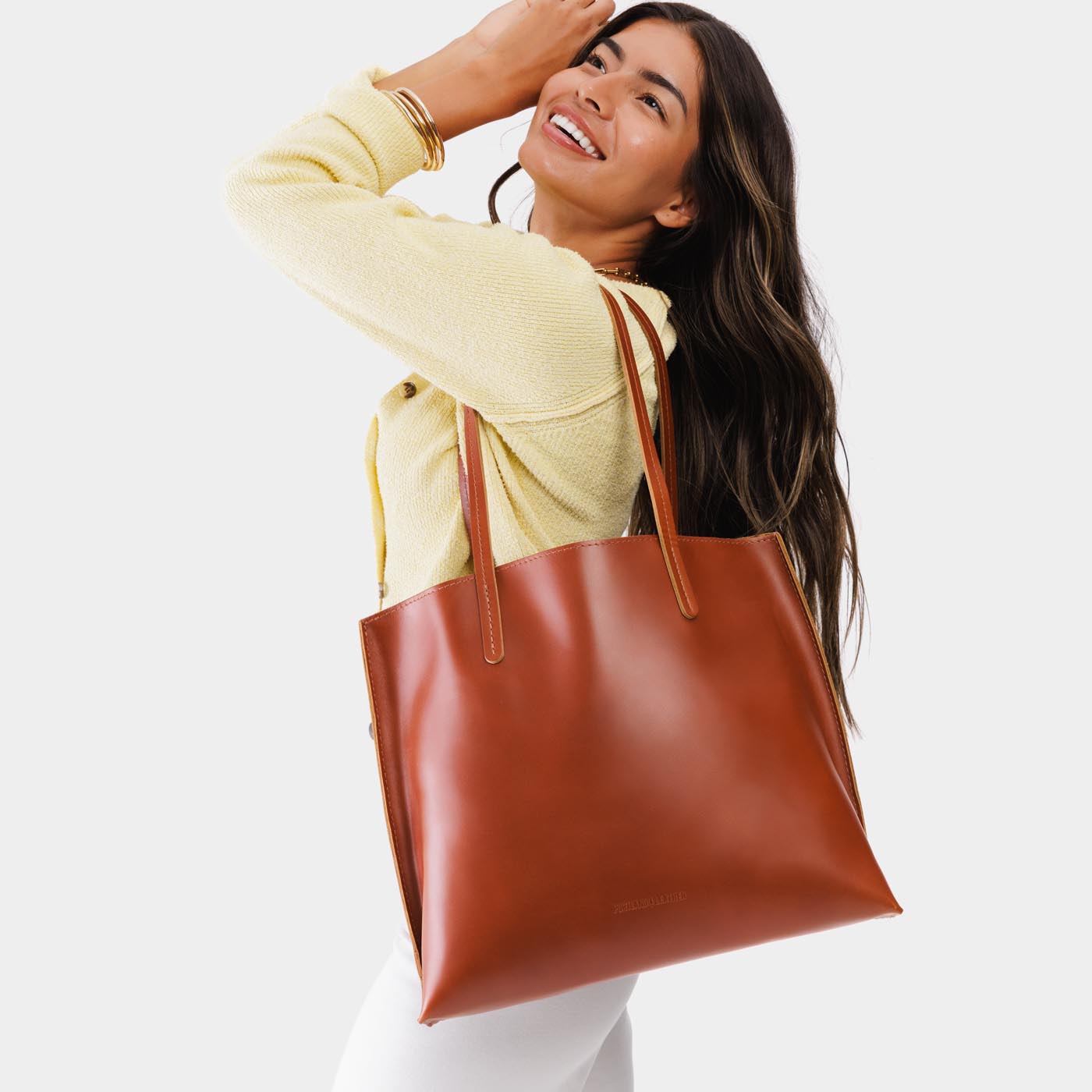 Madrone*Large | Model holding leather tote bag with interior snap key loop