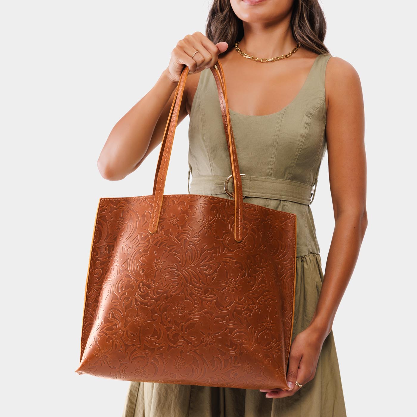 Meadow*Large | Model holding leather tote bag with interior snap key loop