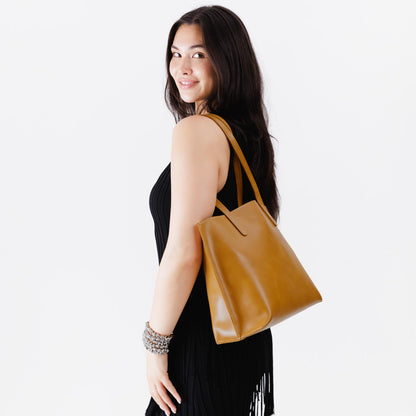 Mango*Medium | Model holding leather tote bag with interior snap key loop