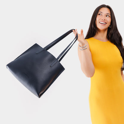 Night Owl*Medium | Model holding leather tote bag with interior snap key loop