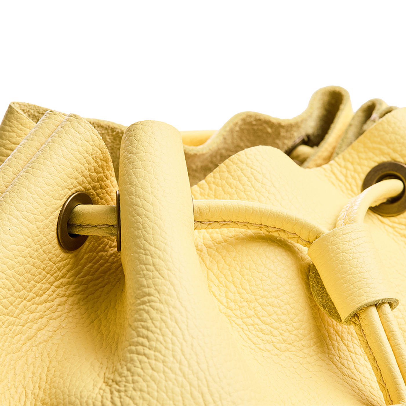 Butter Bliss | Close up of a Drawstring bucket backpack with snap closure
