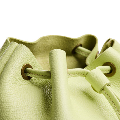 Shadow Lime | Close up of a Drawstring bucket backpack with snap closure