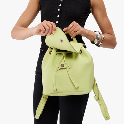 Shadow Lime | Pebbled leather drawstring backpack being worn by a person