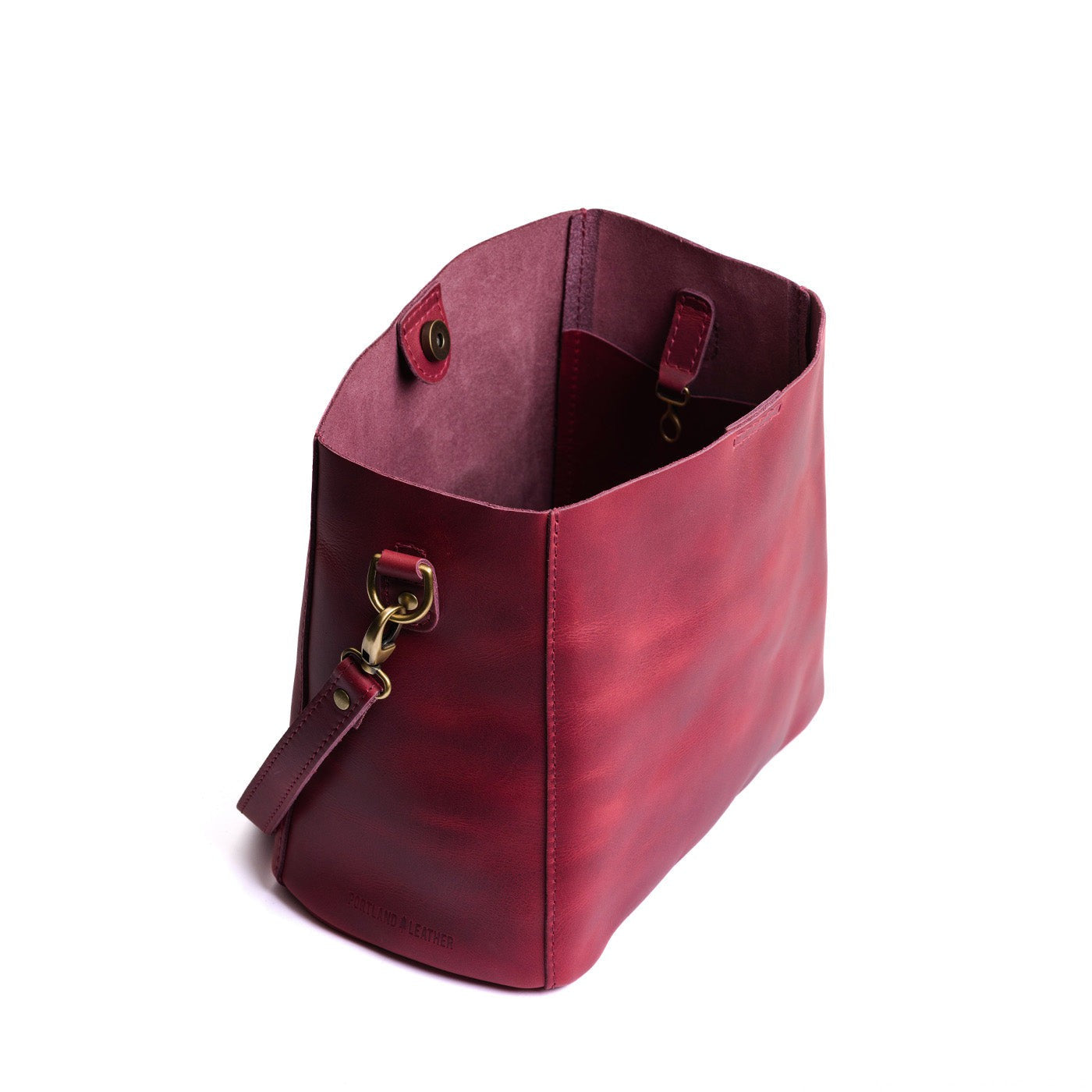 Anemone | symmetrical bucket bag with latch closure and removable crossbody strap