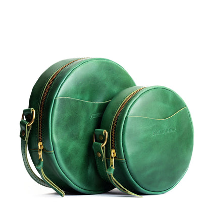 Cowboy Mint | Size comparison image of small and large circle shaped crossbody bags with top zipper