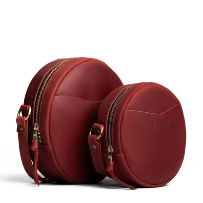 Phoenix | Size comparison image of small and large circle shaped crossbody bags with top zipper