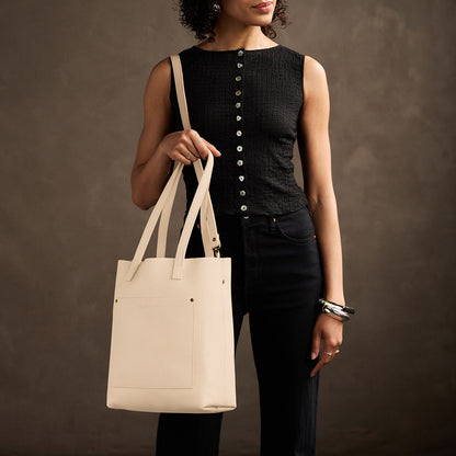 Pebbled Bone*Classic | Model holding medium Tote with dual shoulder straps and crossbody strap
