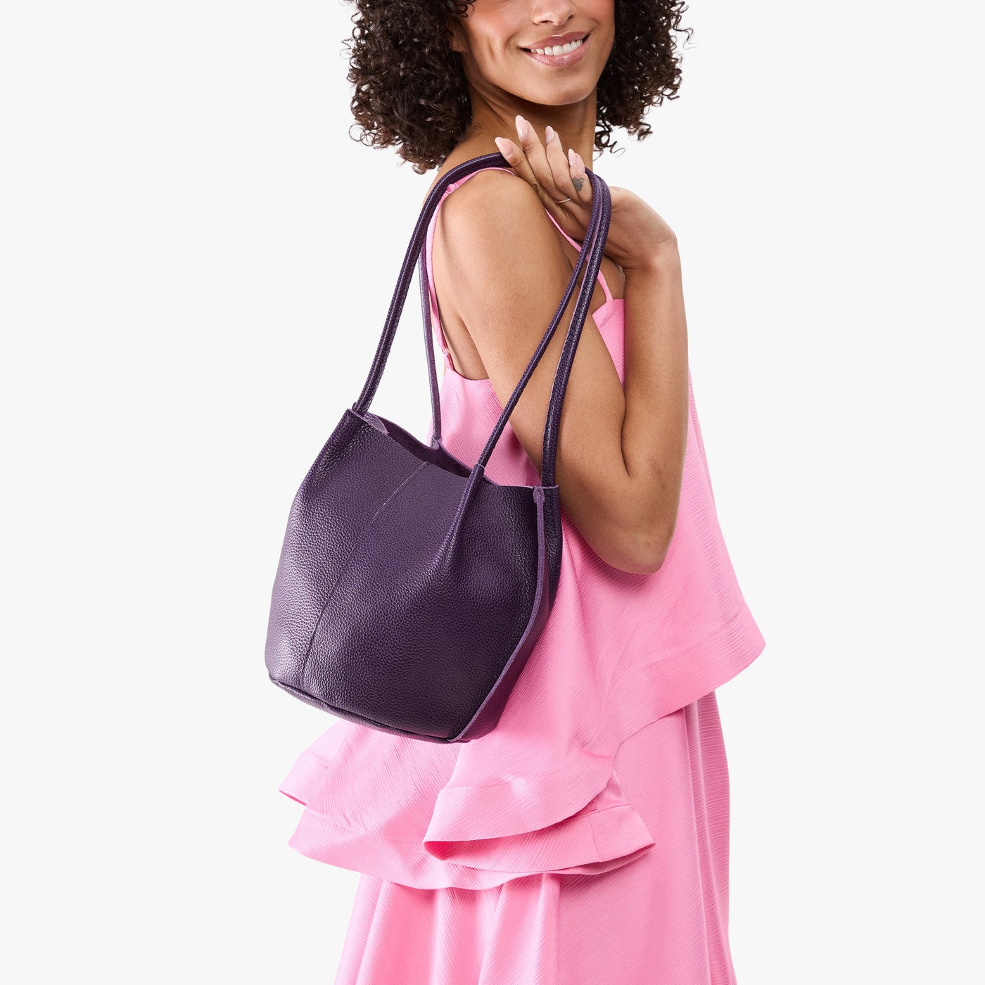 Empire*Small | Model wearing sleeveless pink dress carrying petite bucket shaped tote bag with matching leather handles
