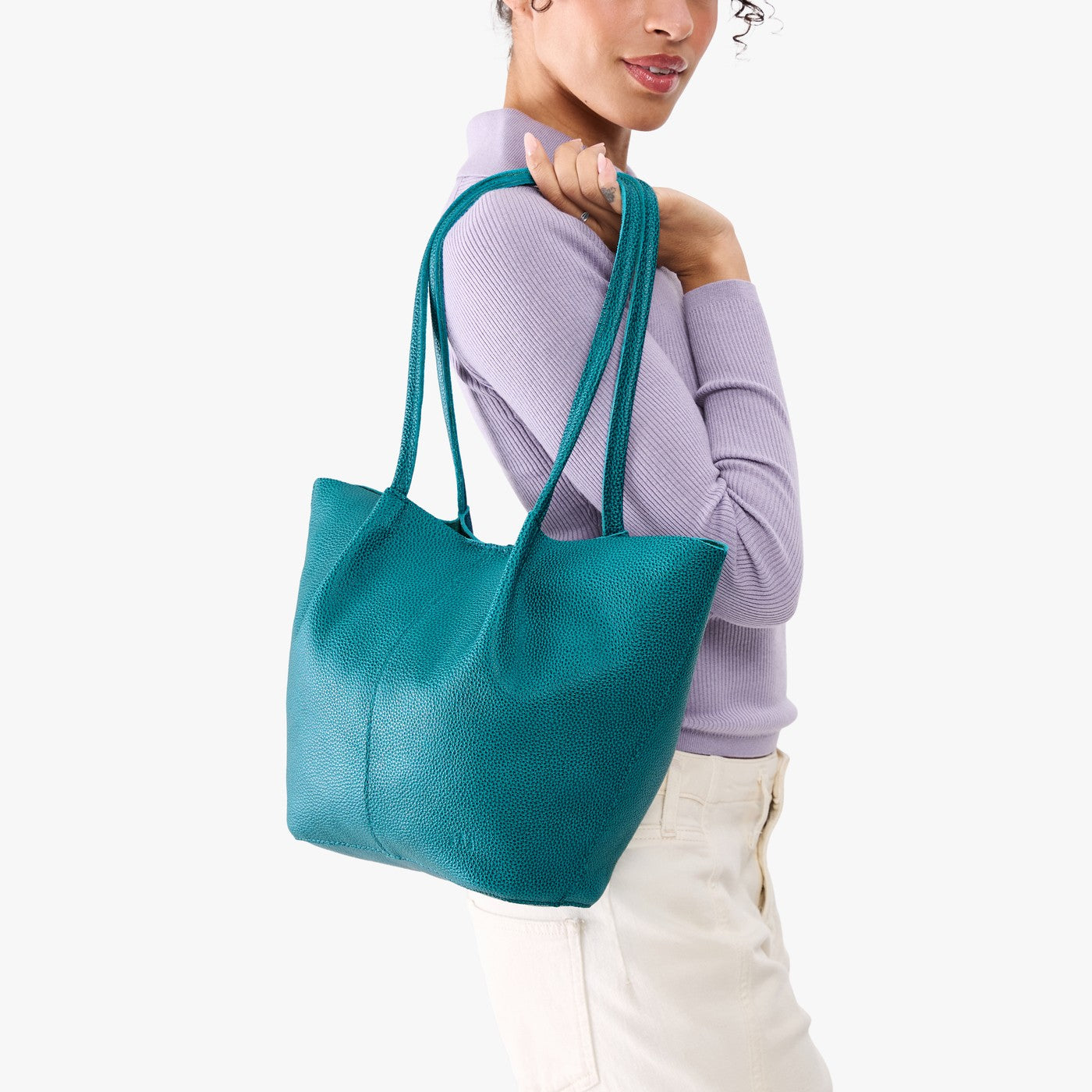 Aquarius*Large | Model wearing lavender sweater and white pants carrying wide bucket shaped tote bag with matching leather handles