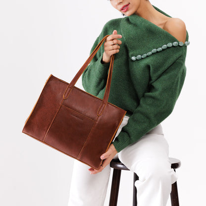 Nutmeg*East/West | Model wearing structured wide tote bag with overlapping panels and crossbody strap