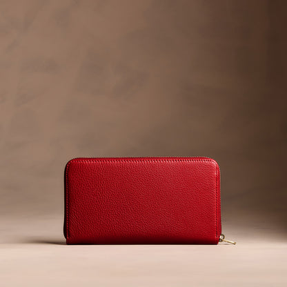 Icon Red | Full zip around wallet with a strap on a brown background