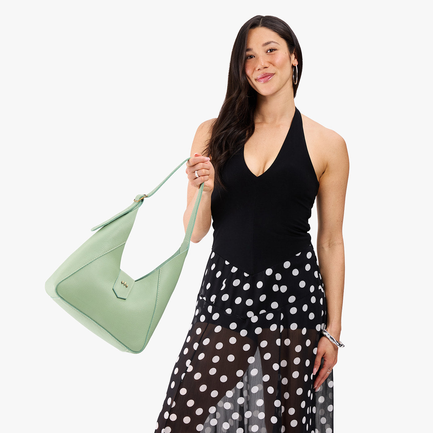 Pistachio | Model wearing structured hobo shoulder bag with adjustable strap and magnetic closure