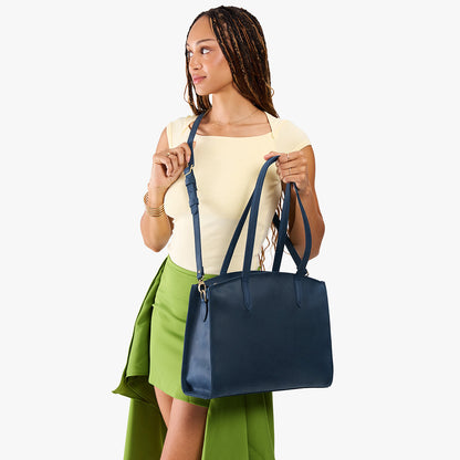 Deep Water*Large | Model carrying leather tote bag with handles, adjustable crossbody strap, and two back pockets