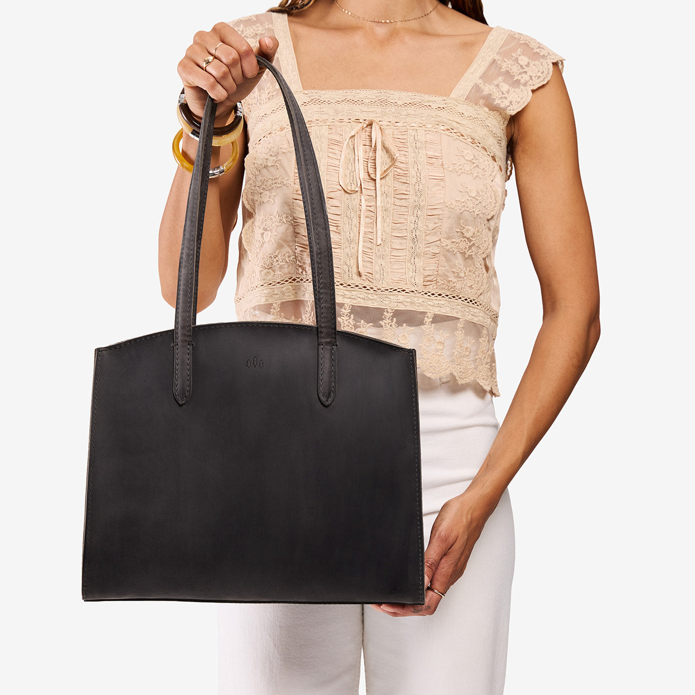 Full Moon*Large | Model carrying leather tote bag with handles, adjustable crossbody strap, and two back pockets