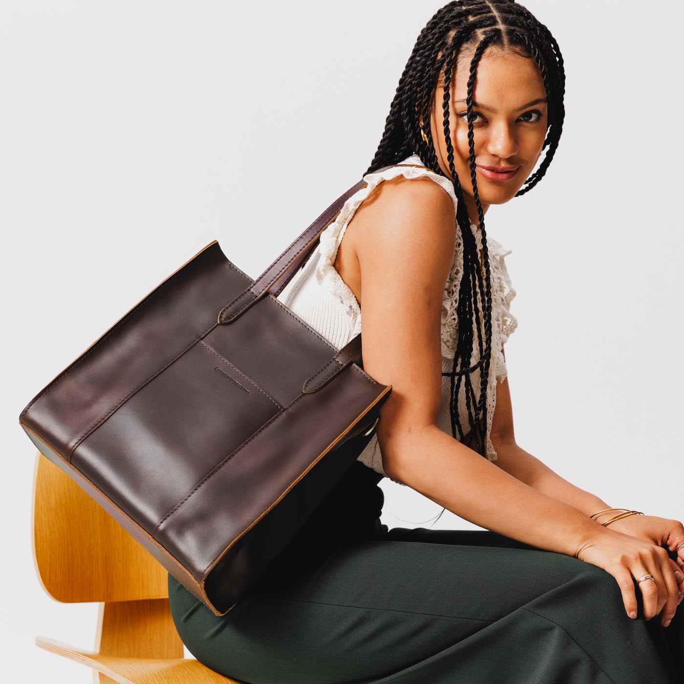 Grizzly*North/South | Model wearing structured large tote bag with overlapping panels and crossbody strap