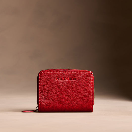 Icon Red | Wallet with card and storage pockets on a light brown background