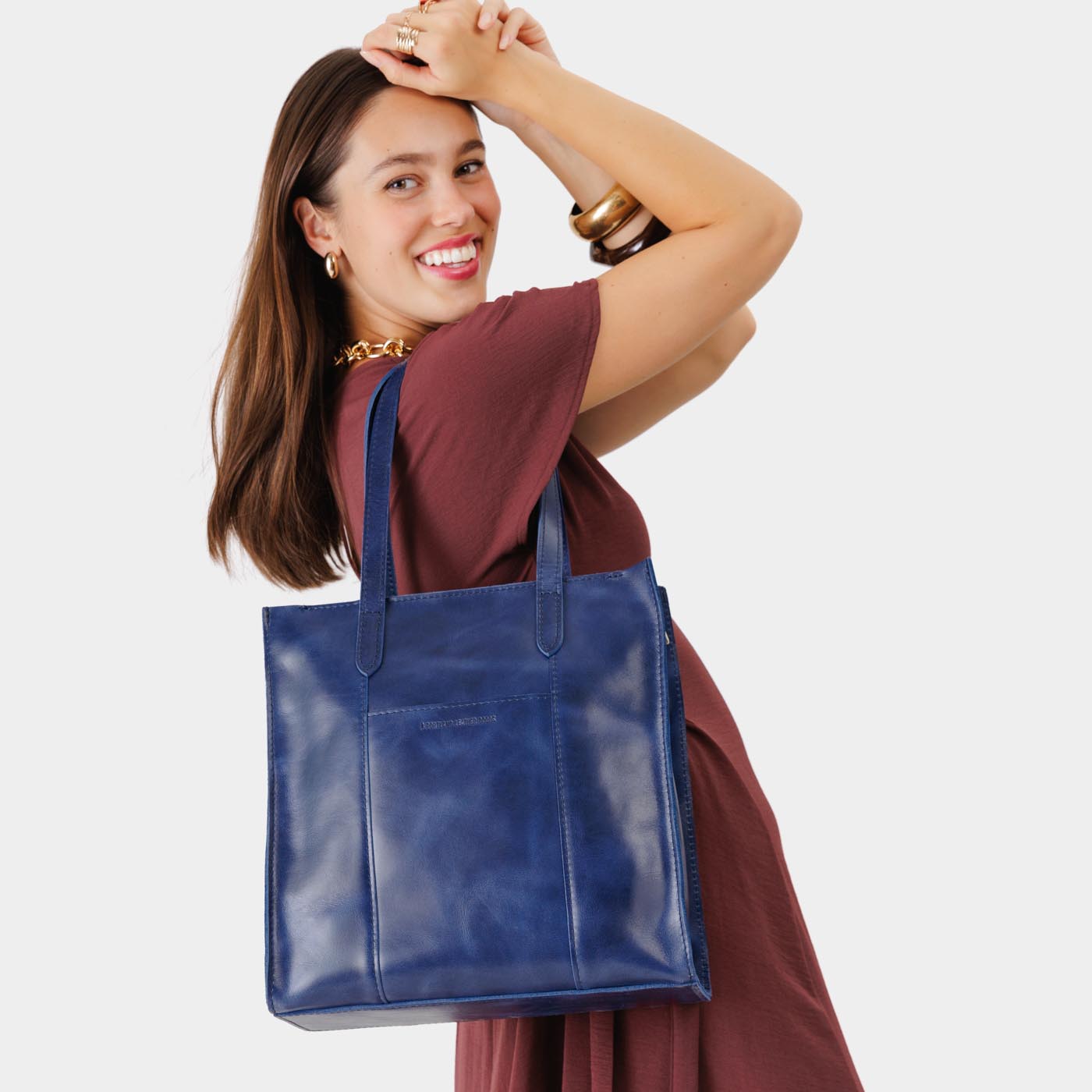 Cowboy Blue*North/South | Model wearing structured large tote bag with overlapping panels and crossbody strap