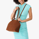 Wildwood*Large | Model holding a half circle crossbody bag with handles and removable crossbody strap