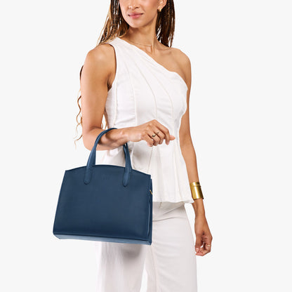 Deep Water*Medium | Model carrying leather tote bag with handles, adjustable crossbody strap, and two back pockets
