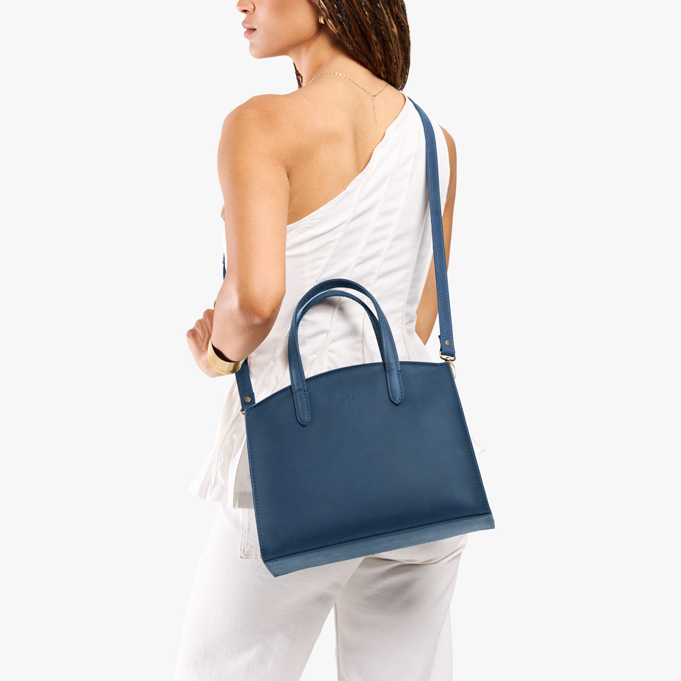 Deep Water*Medium | Model wearing leather tote bag with handles, adjustable crossbody strap, and two back pockets