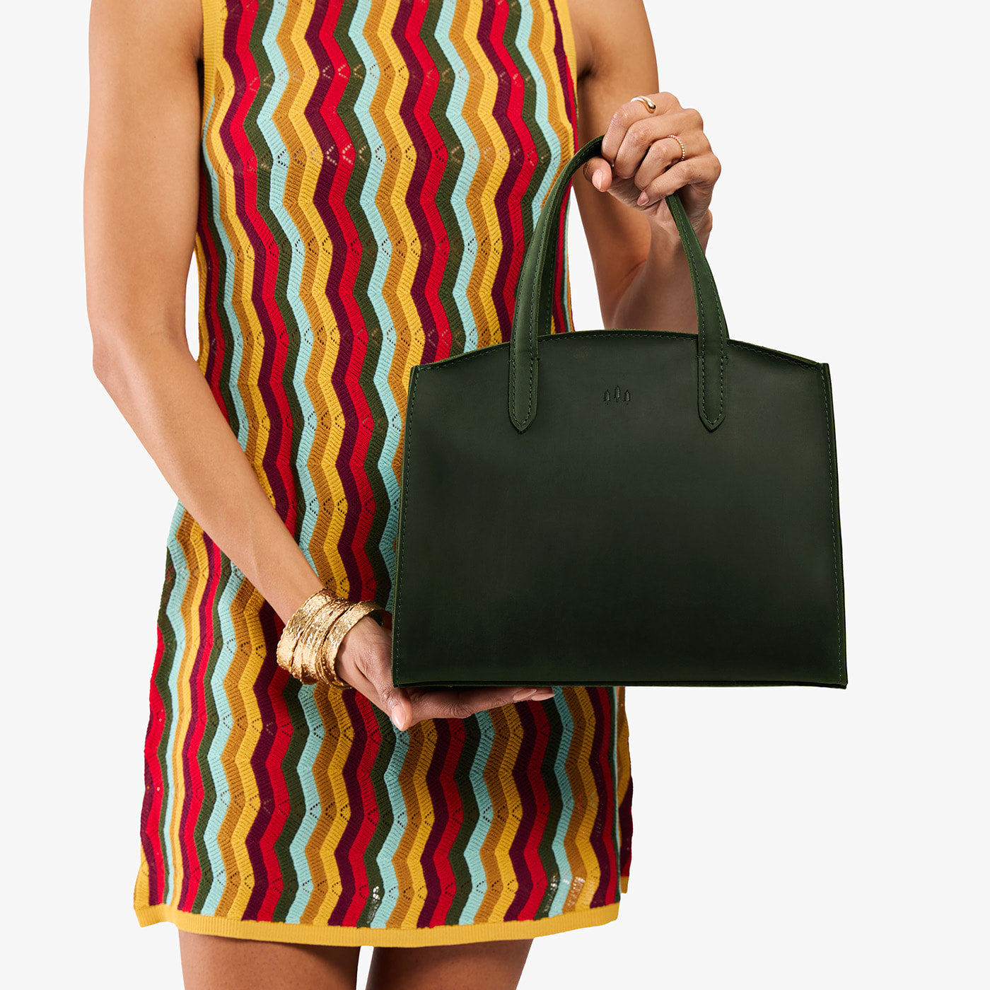 Evergreen*Medium | Model carrying leather tote bag with handles, adjustable crossbody strap, and two back pockets