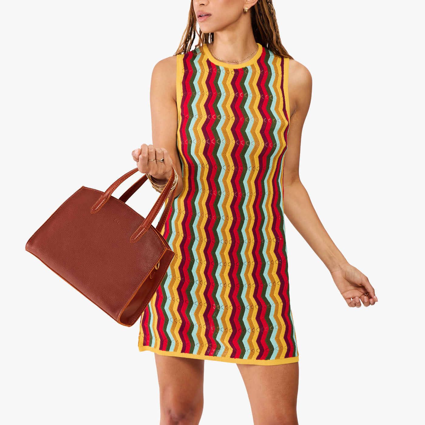 Nutmeg*Medium | Model carrying leather tote bag with handles, adjustable crossbody strap, and two back pockets