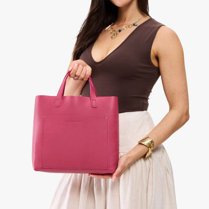 Wild Rose*Classic | Model holding midsize crossbody tote with handles and a pocket