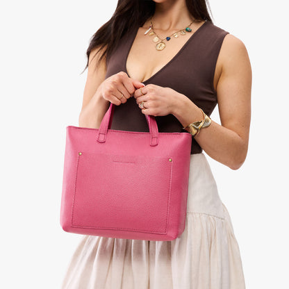 Wild Rose*Zipper | Model holding midsize crossbody tote with handles and a pocket