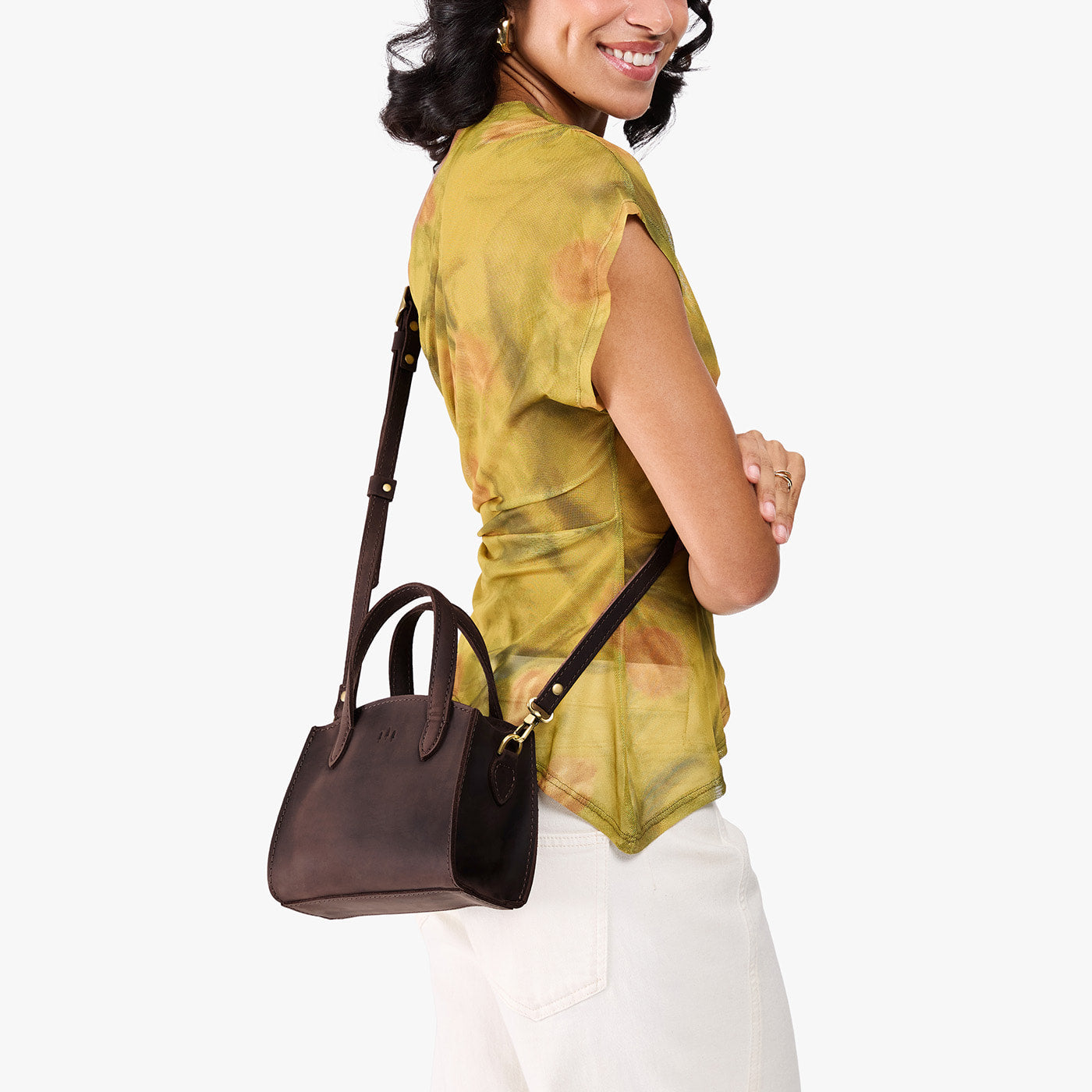 Moose*Mini | Model carrying small leather tote bag with handles, adjustable crossbody strap, and one back pocket
