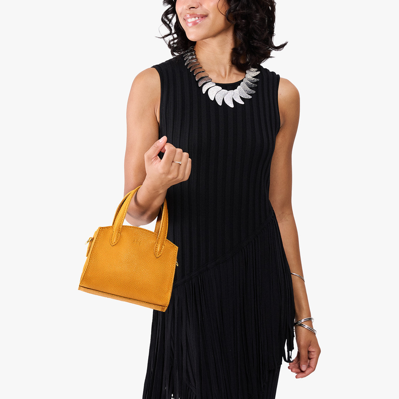Sunshine*Mini | Model carrying small leather tote bag with handles, adjustable crossbody strap, and one back pocket