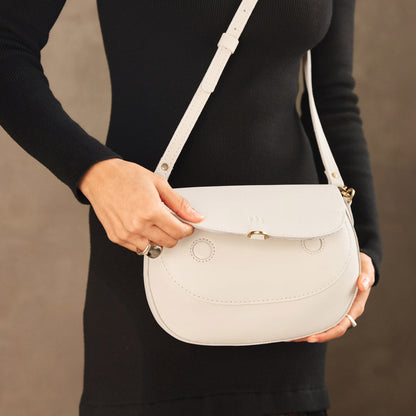 Bone*Large | Model wearing a leather Crossbody with a flap and magnetic closure