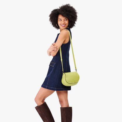 Wasabi*Small | Model wearing a petite leather Crossbody with a flap and magnetic closure