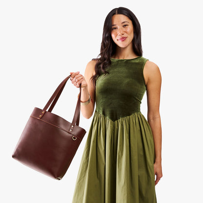 Cognac*Medium*Classic | Model wearing leather tote bag with riveted straps and exterior key loop