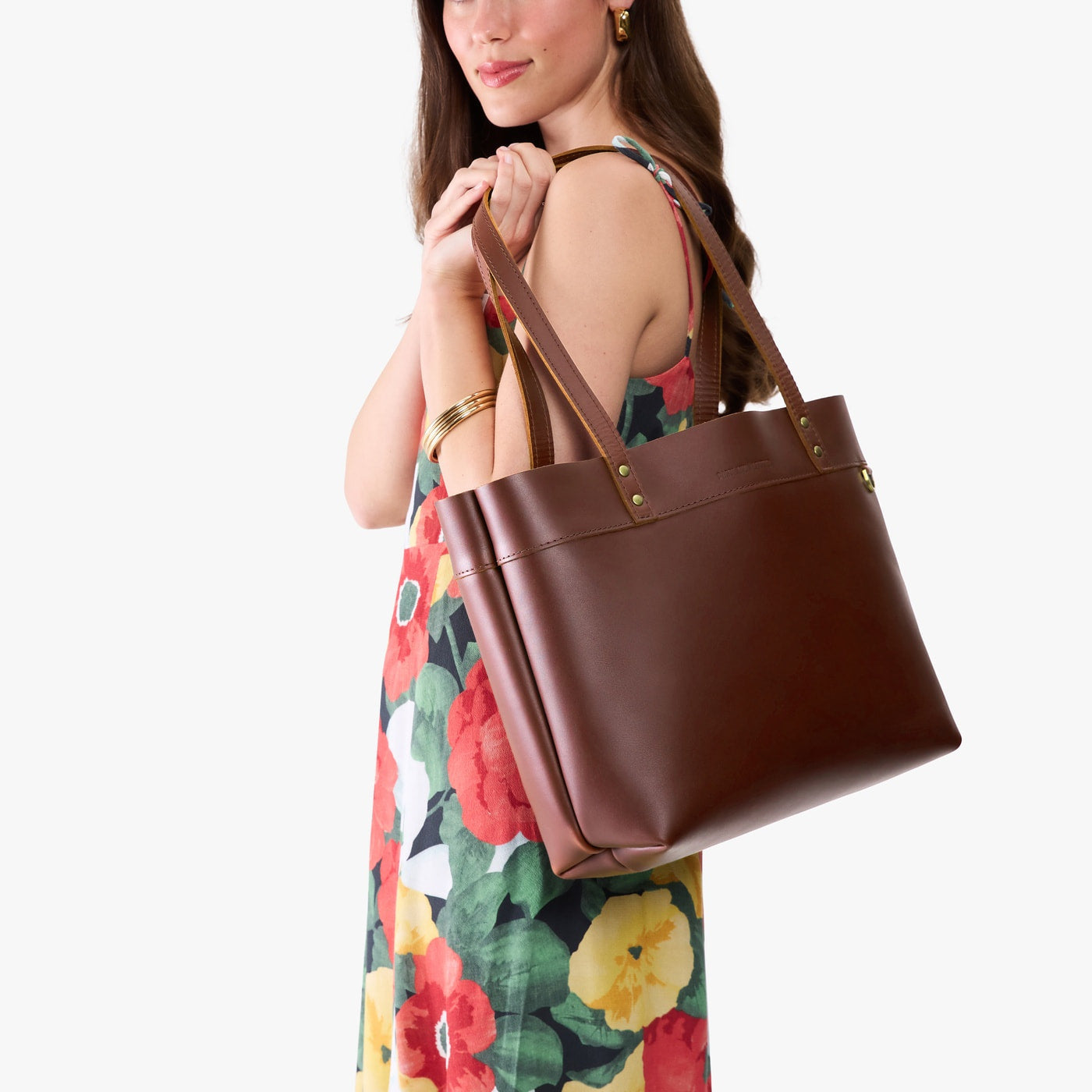 Cognac*Large*Classic | Model wearing leather tote bag with riveted straps and exterior key loop