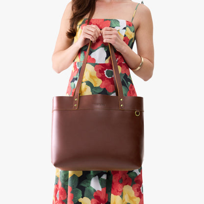 Cognac*Large*Classic | Model wearing leather tote bag with riveted straps and exterior key loop