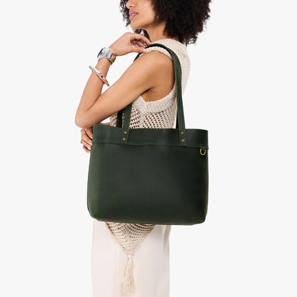 Evergreen*Large*Classic | Model wearing leather tote bag with riveted straps and exterior key loop