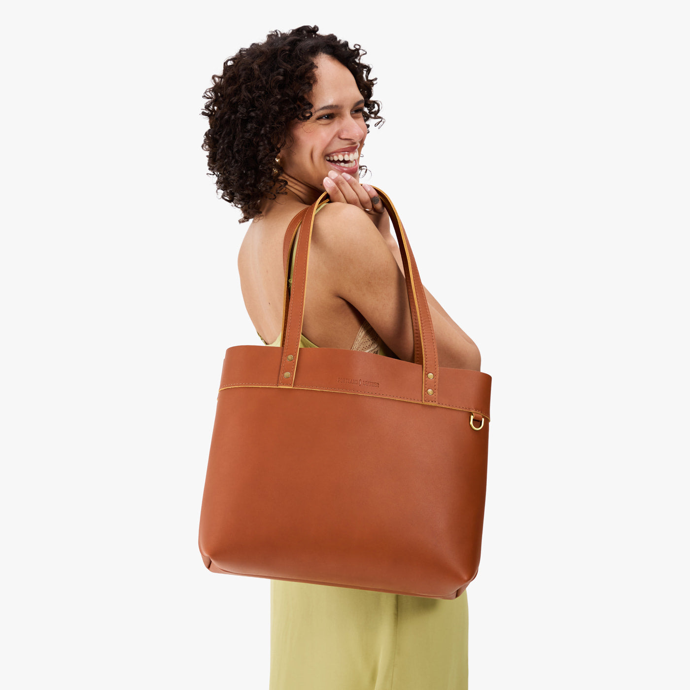 Honey*Large*Classic | Model wearing leather tote bag with riveted straps and exterior key loop
