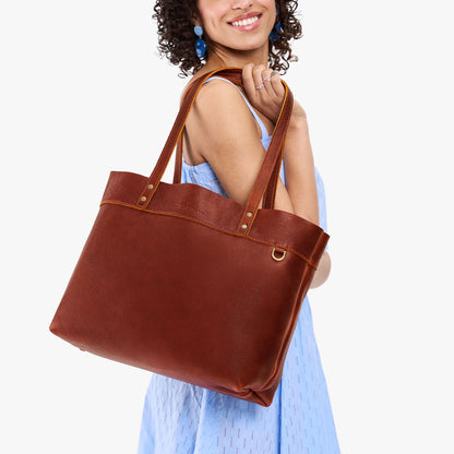 Nutmeg*Large*Classic | Model wearing leather tote bag with riveted straps and exterior key loop