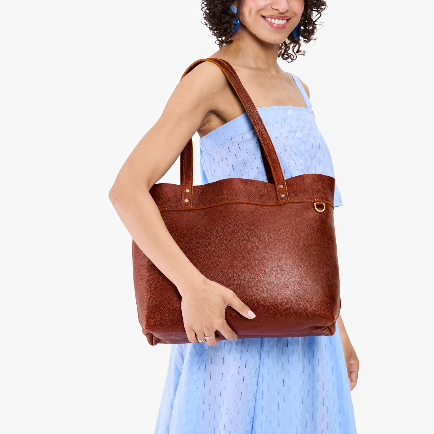 Nutmeg*Large*Classic | Model wearing leather tote bag with riveted straps and exterior key loop