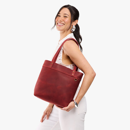 Phoenix*Medium*Classic | Model wearing leather tote bag with riveted straps and exterior key loop