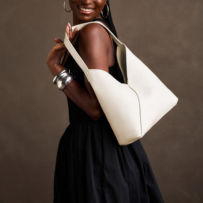 Pebbled Bone*Large | Model carrying mid-size shoulder bag with magnetic snap closure