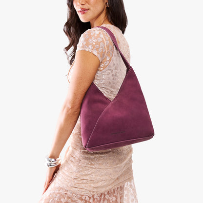 Superbloom*Large | Model wearing mid-size shoulder bag with magnetic snap closure